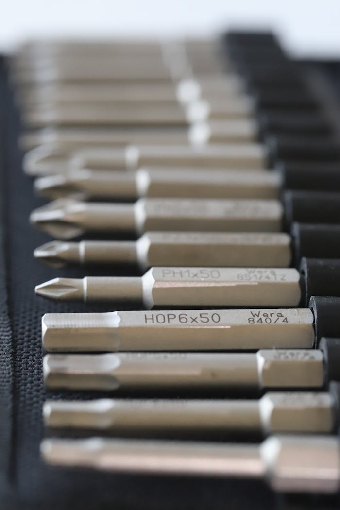 Detailed view of metallic tool bits arranged neatly, perfect for industrial use.